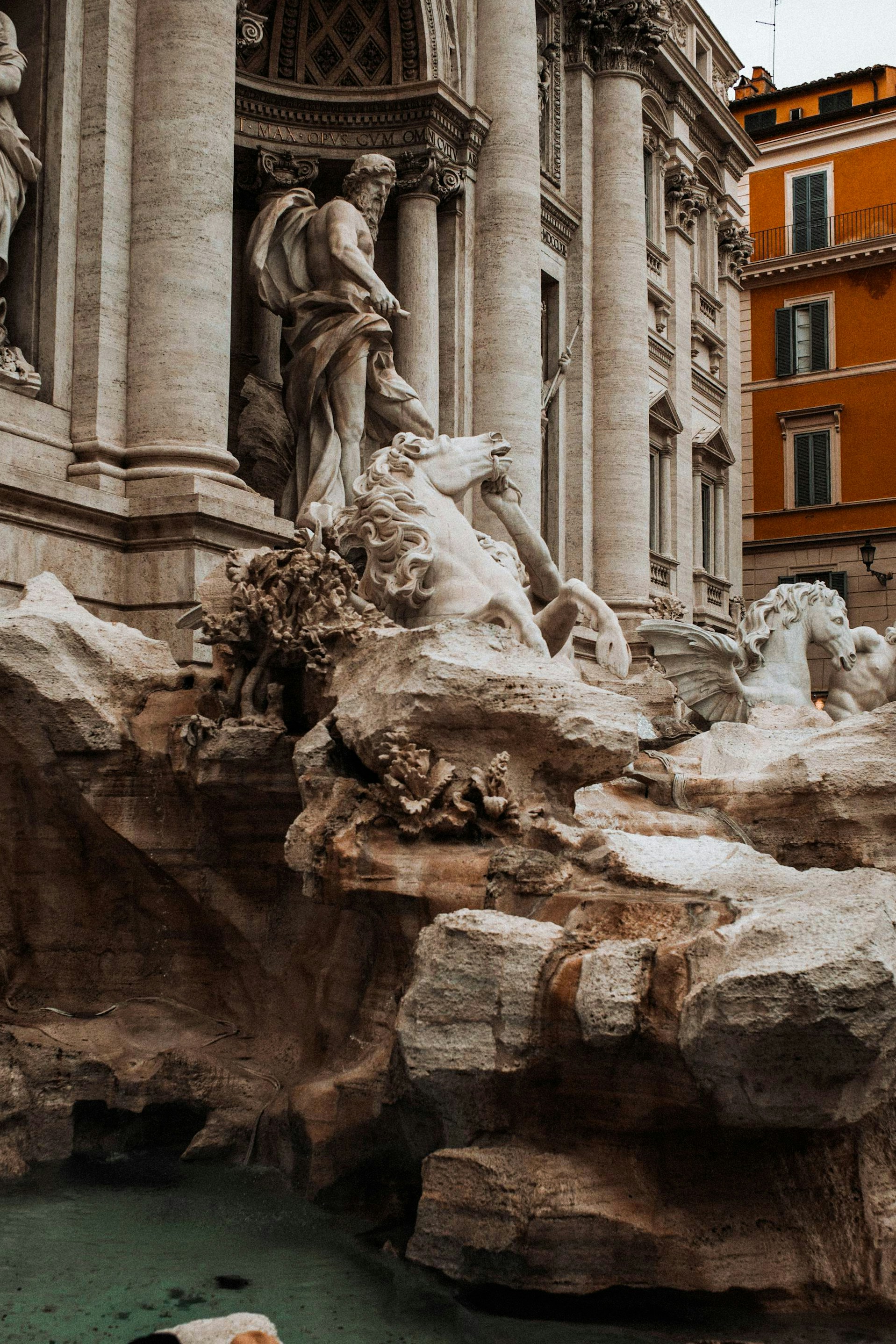 A small boat is in the water near a building