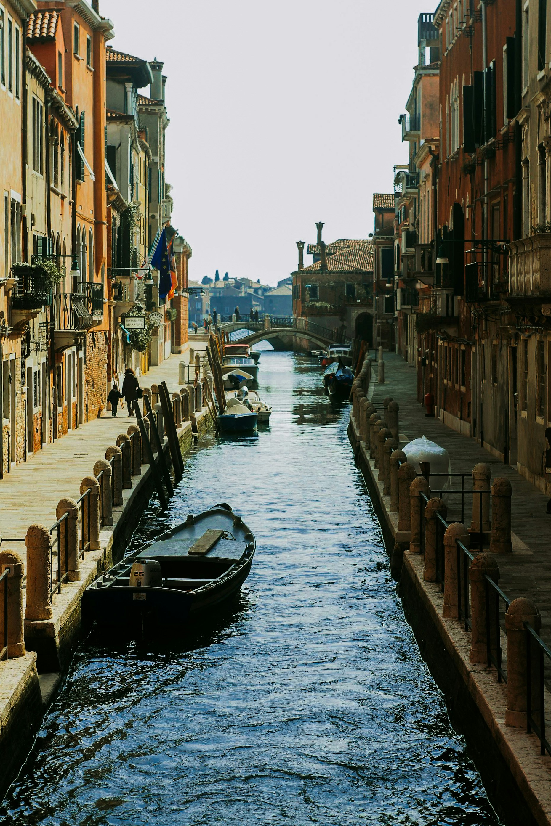 A narrow waterway with boats in the middle of it