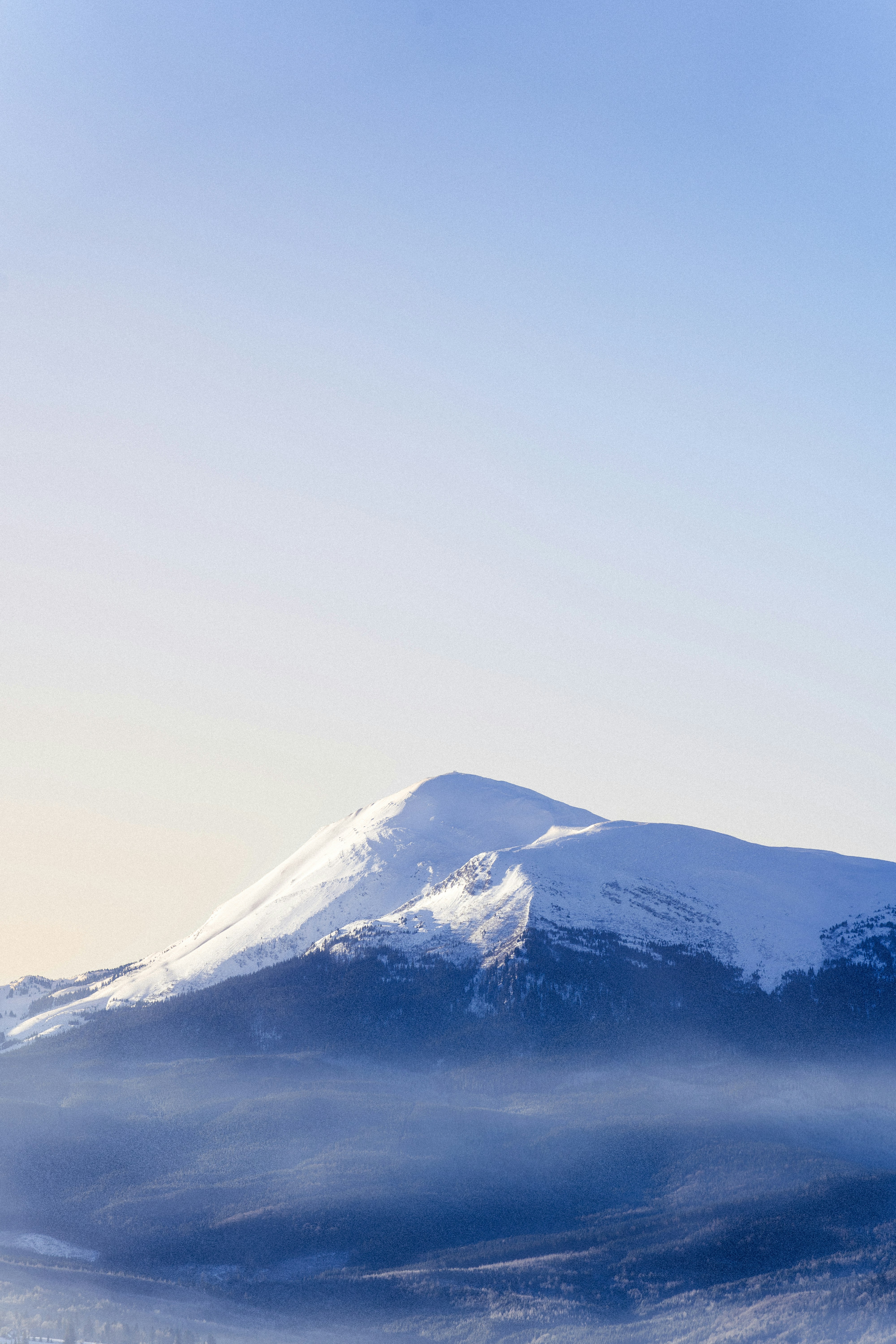 A snowboarder is doing a trick in the air