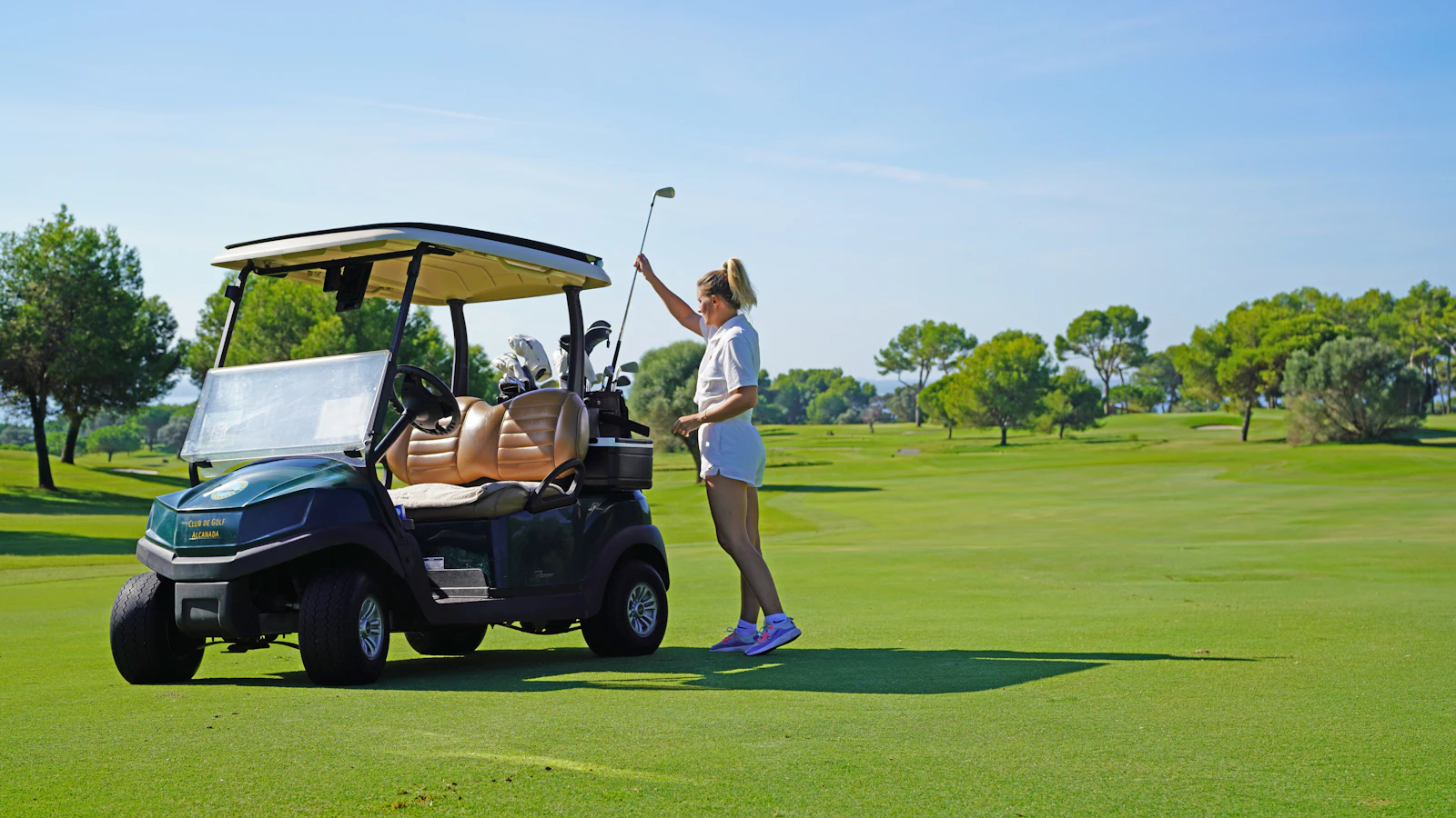 Member beside a golf cart on the fairway