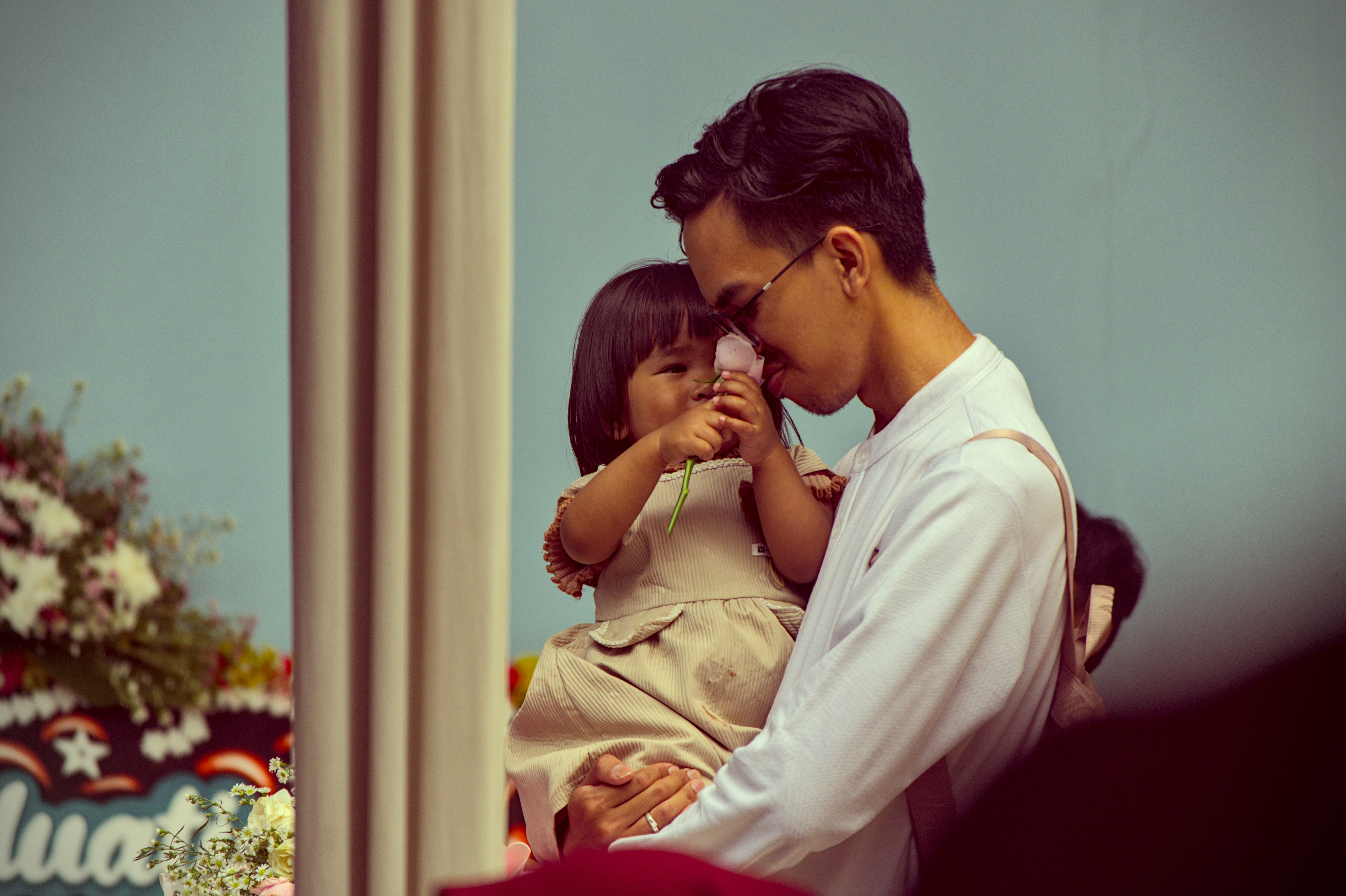 A man and a little girl standing next to each other