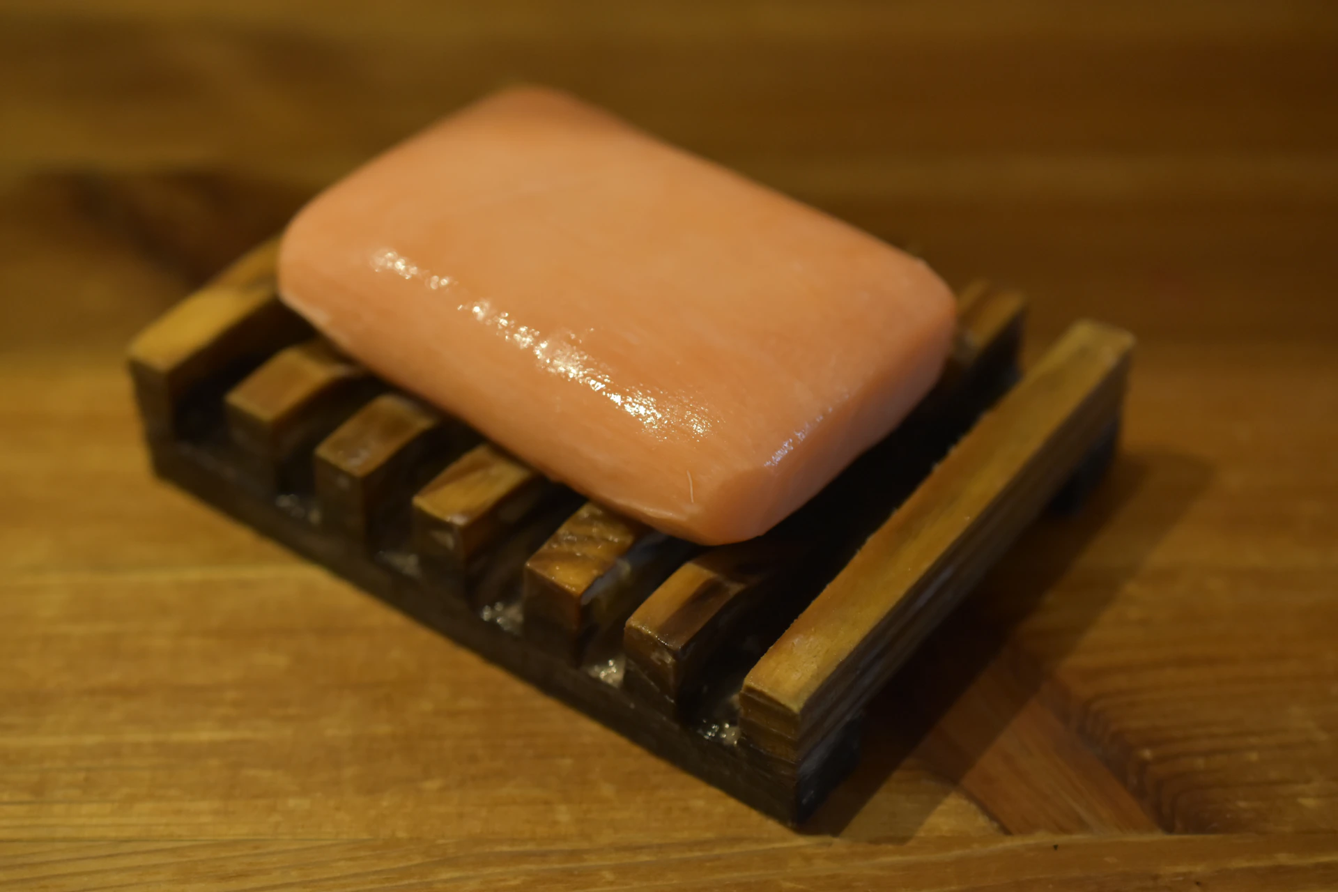 A piece of soap sitting on top of a wooden block