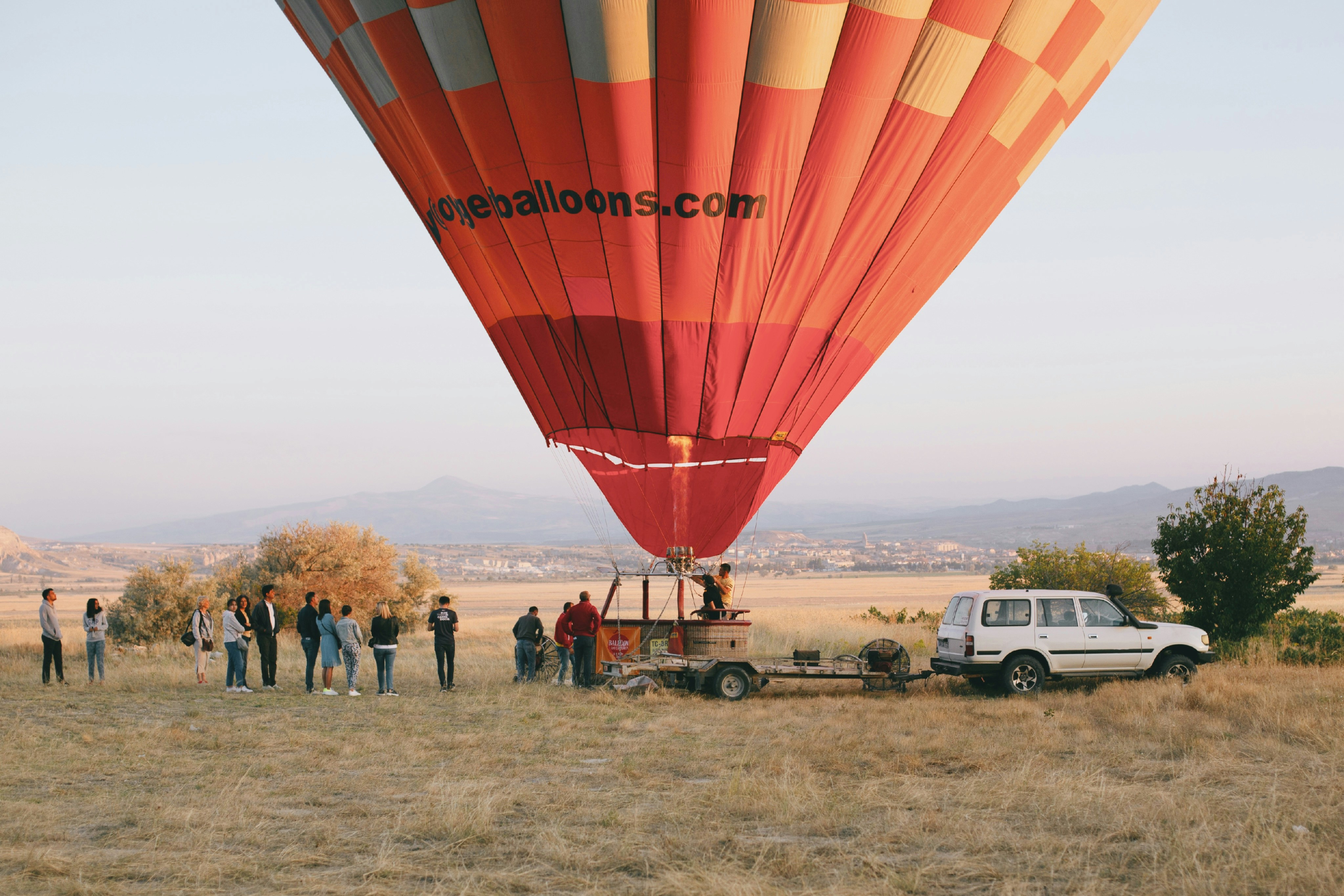 A group of people standing around a hot air balloon