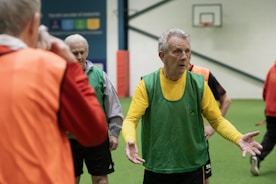 A group of men standing on top of a green field