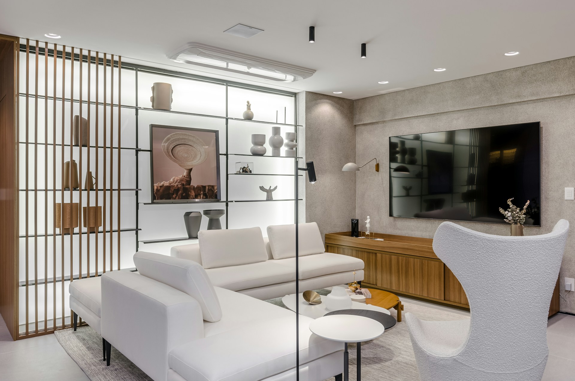A living room with a white couch and a white chair