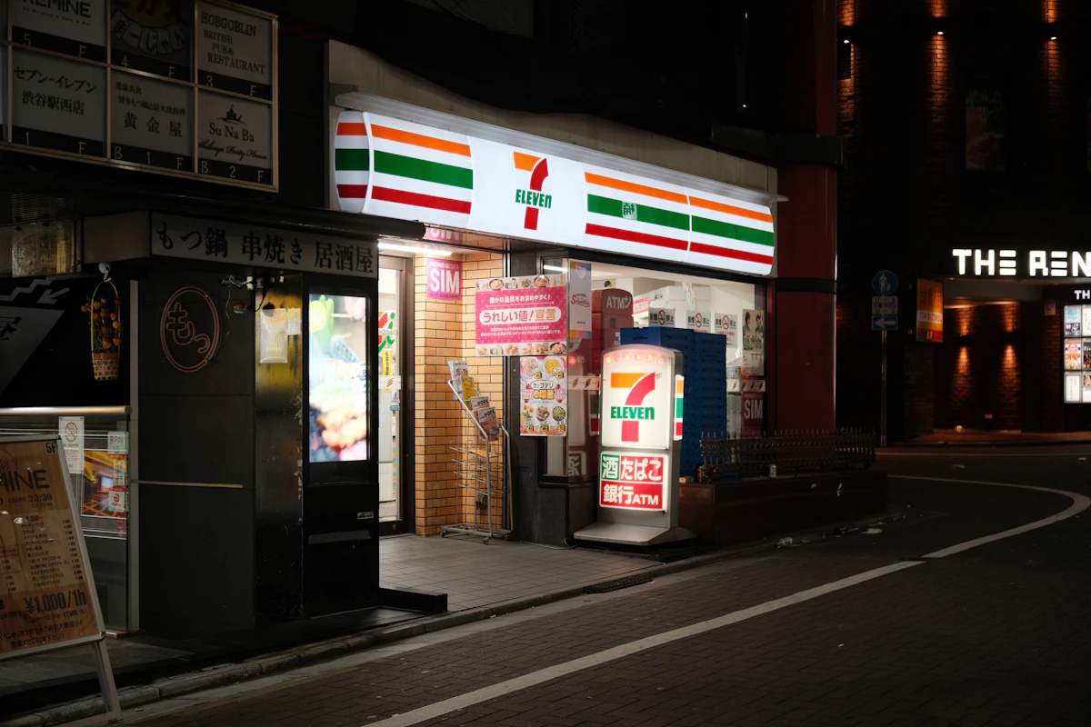 Japanese Kirin canned drinks vending machine glowing at night in a Tokyo alley