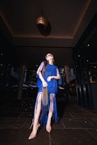 A woman in a blue dress posing for a picture