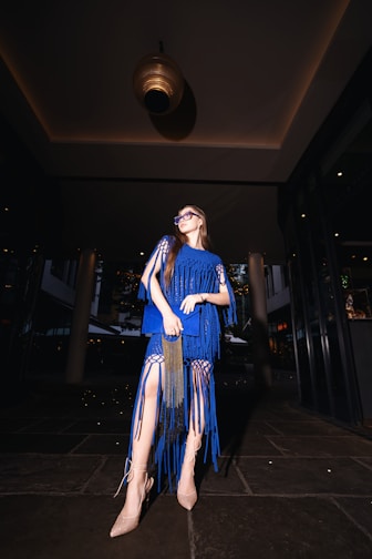 A woman in a blue dress posing for a picture