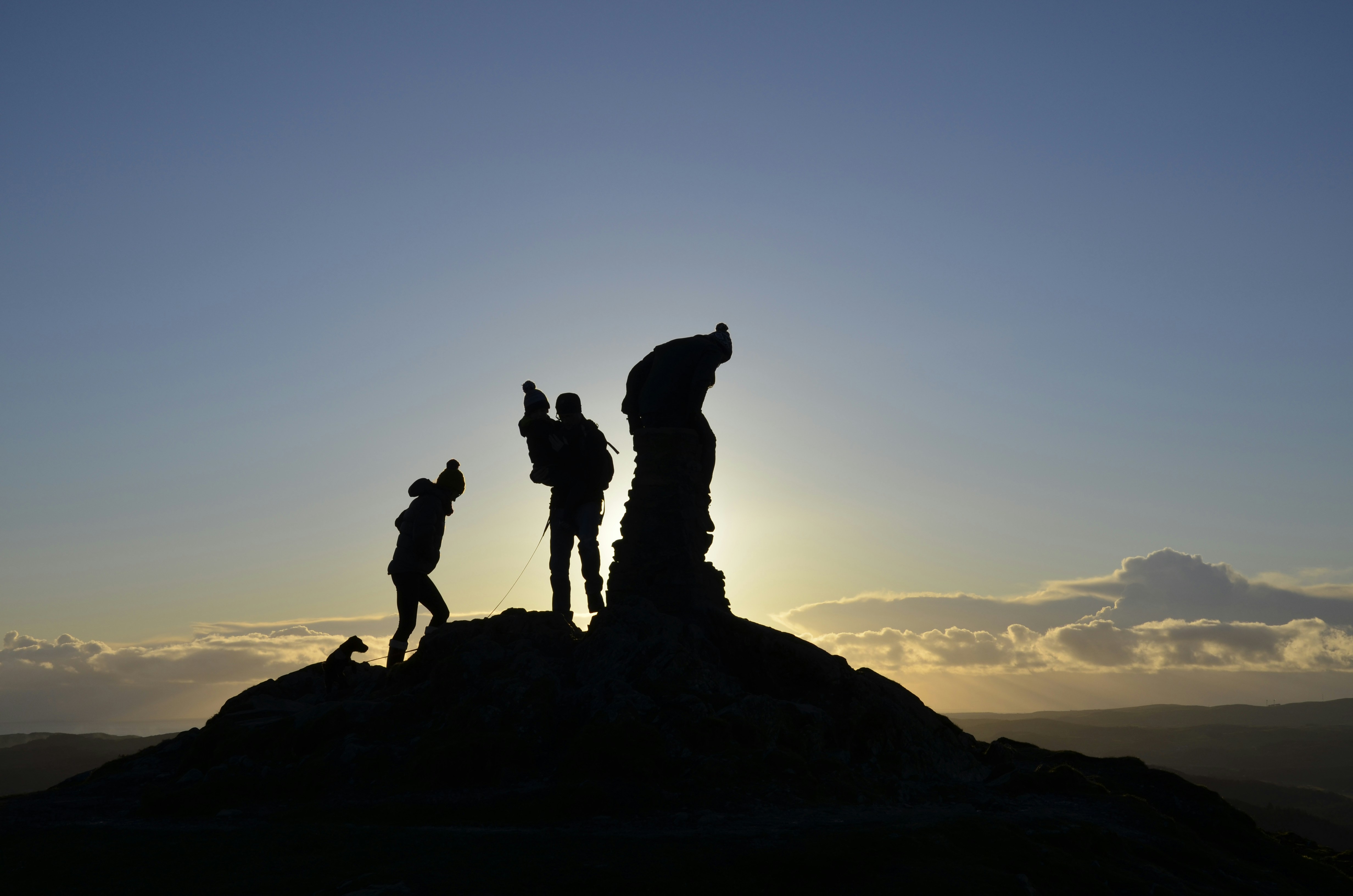 A group of people standing on top of a mountain