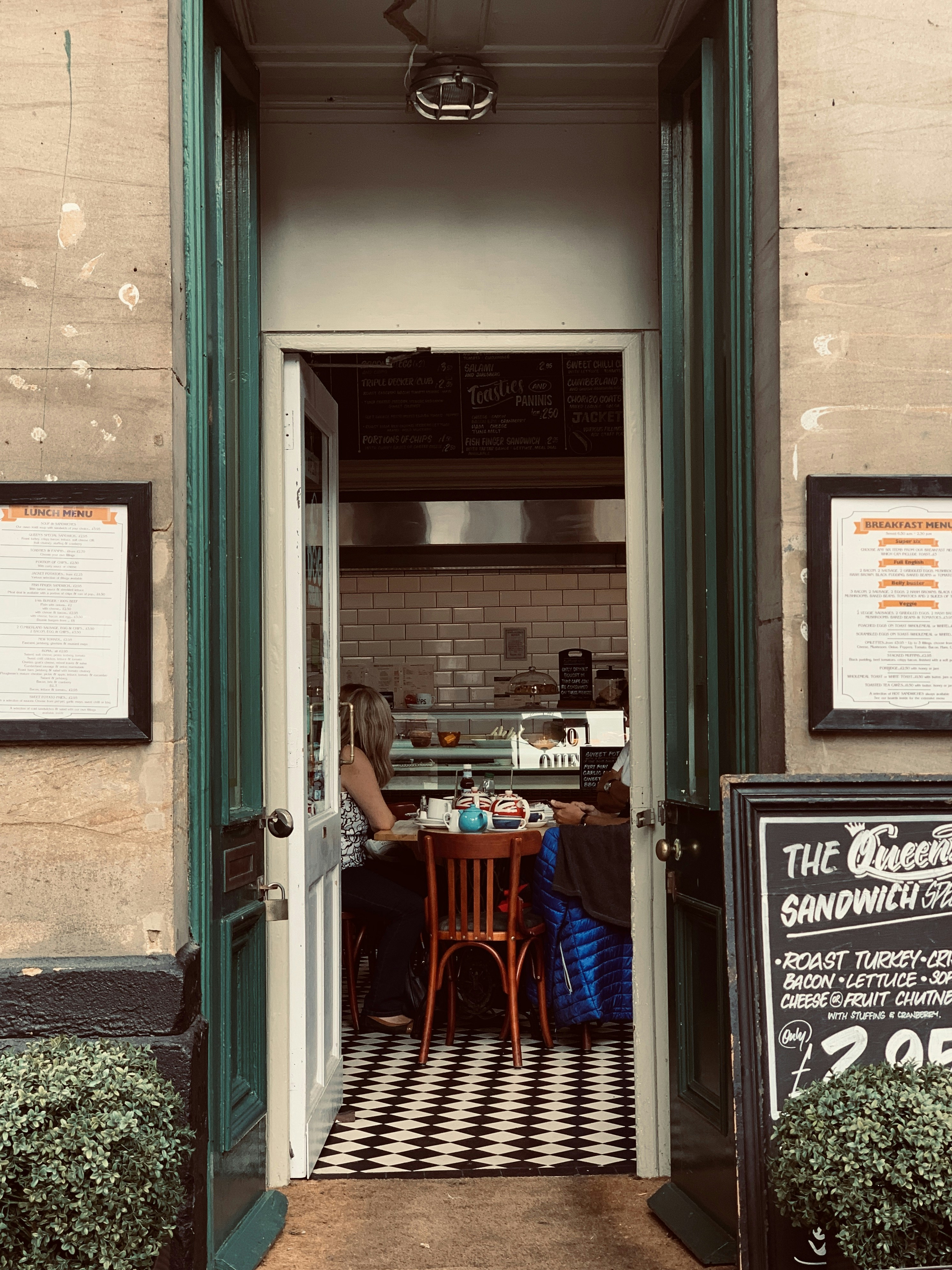 A couple of people sitting at a table outside of a restaurant