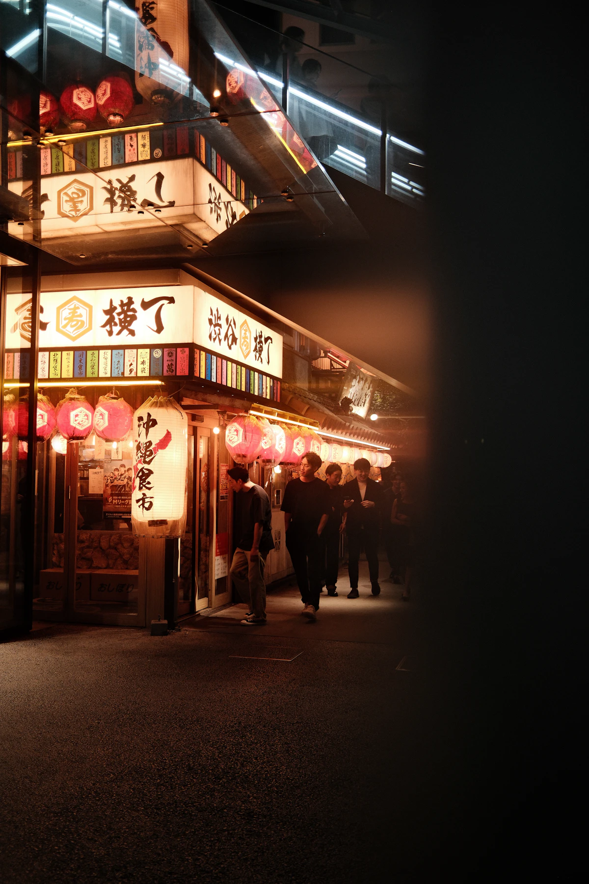 A group of friends walking together through neon-lit city streets at night