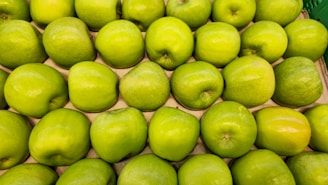 A pile of green apples sitting next to each other