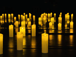 A number of lit candles on a table