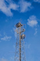 A very tall tower with a bunch of antennas on top of it