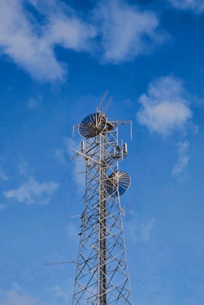 A very tall tower with a bunch of antennas on top of it