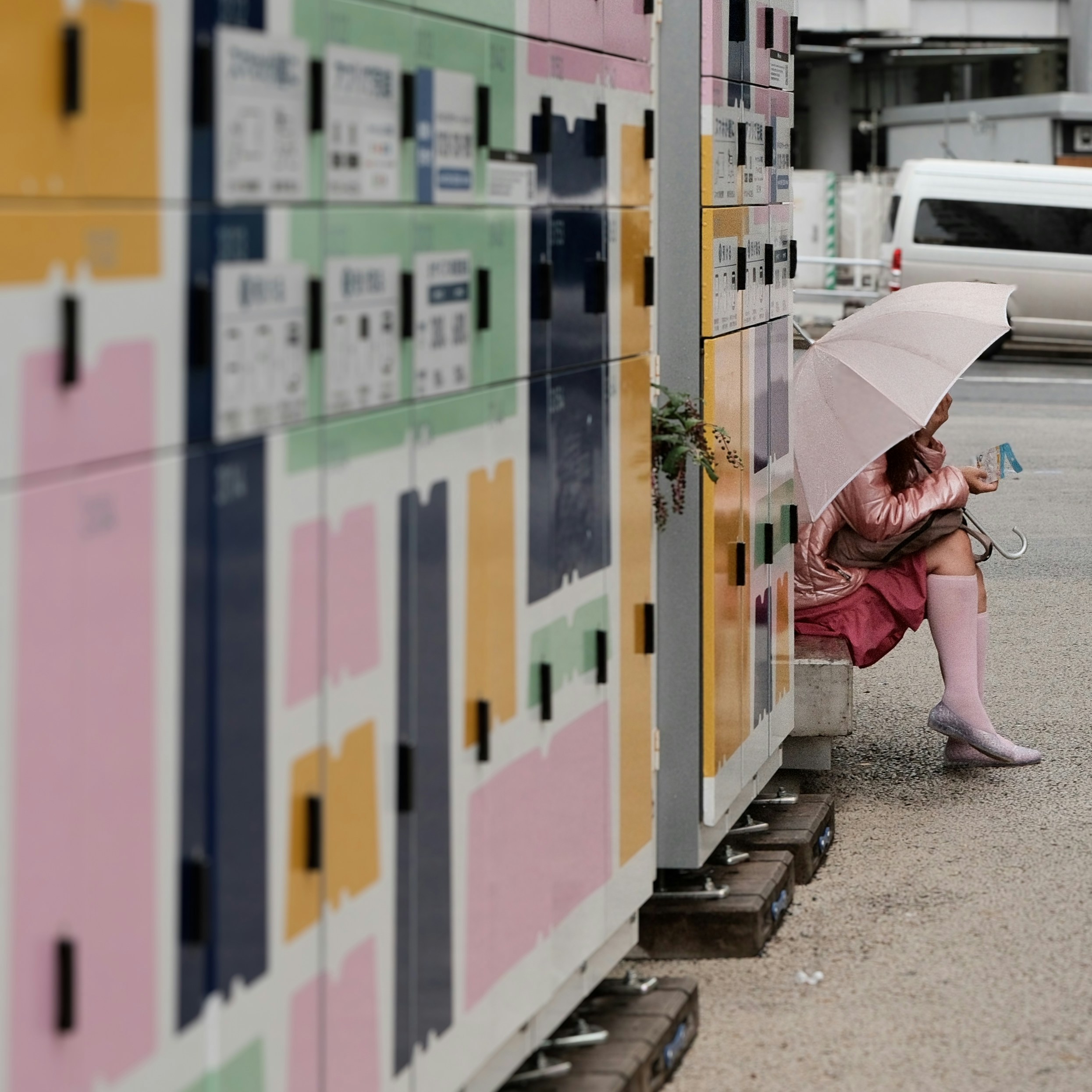 A woman sitting on a bench with an umbrella