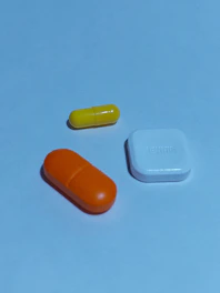 A group of three pills sitting next to each other