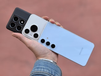 A person holding a cell phone in their hand