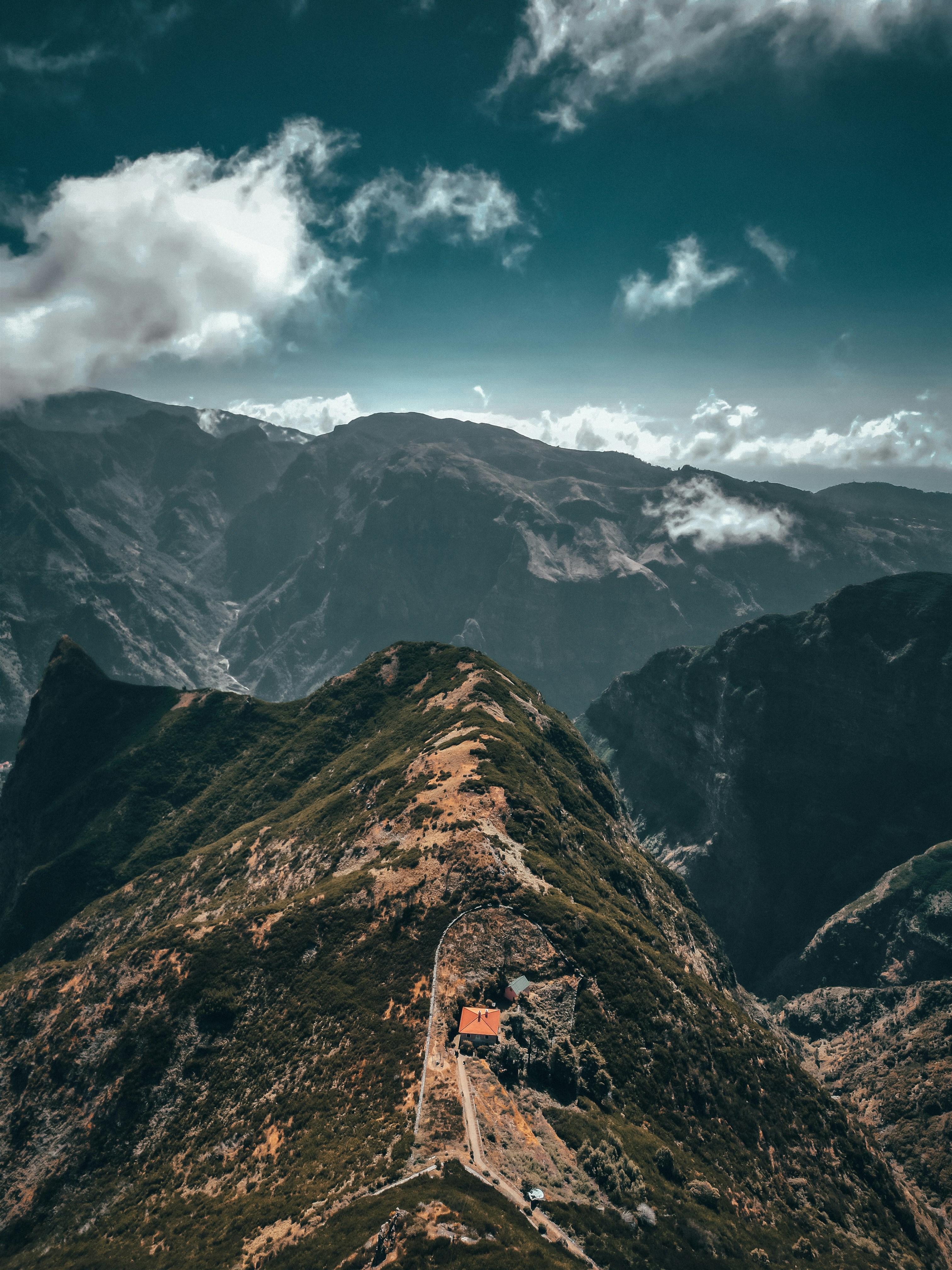A view of a mountain range from the top of a hill