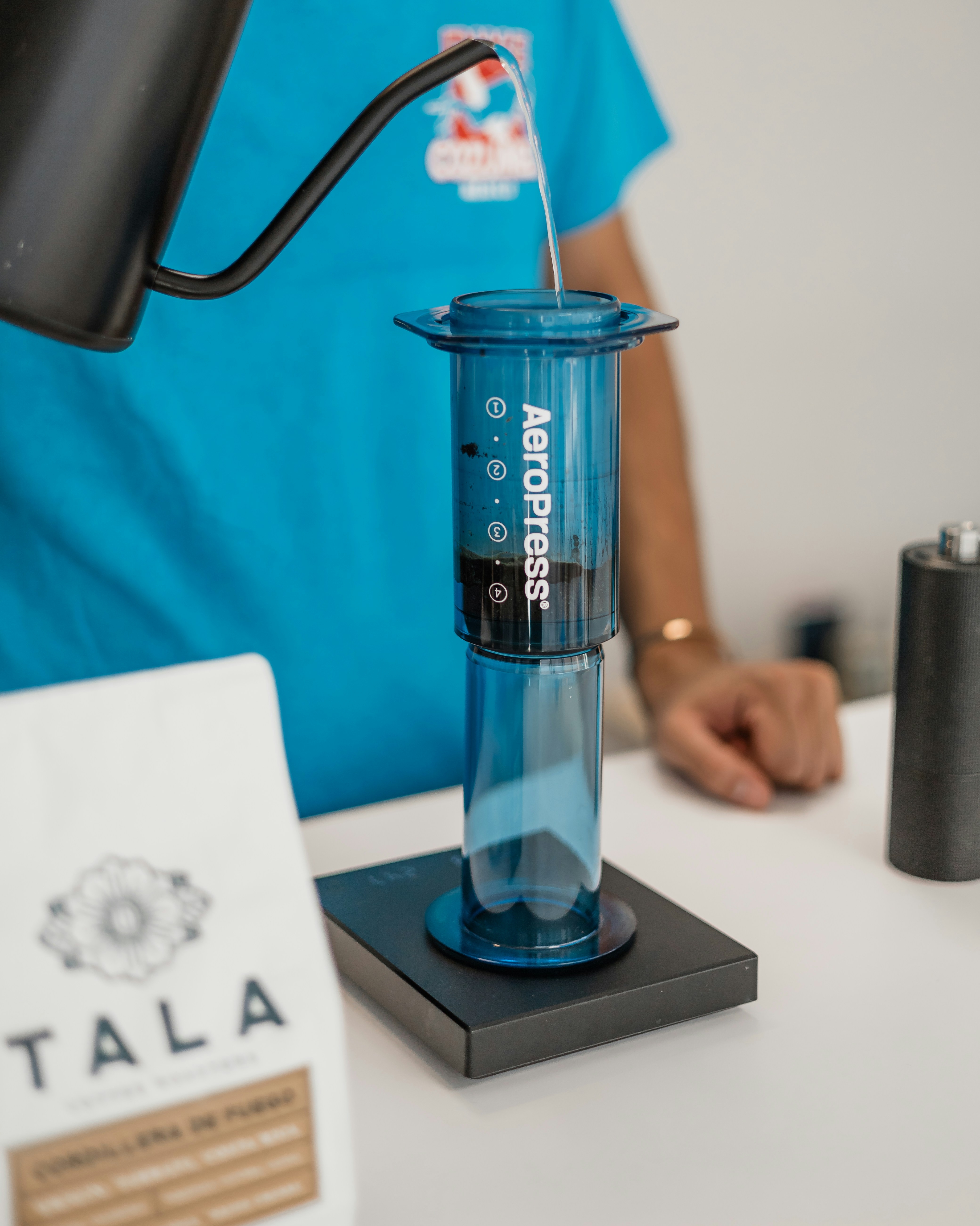 A person is pouring something into a beakle