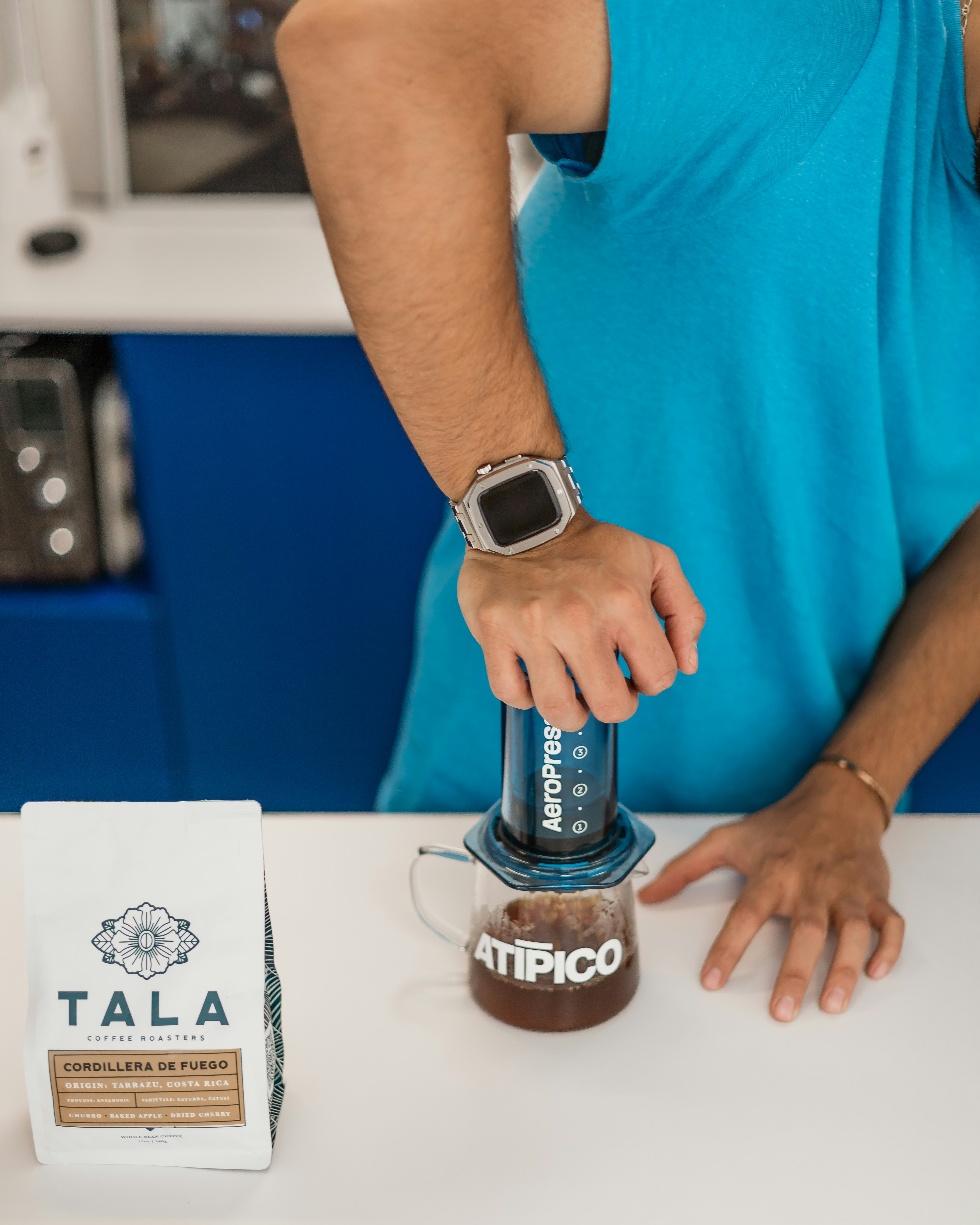 A man pouring a cup of coffee into a blender