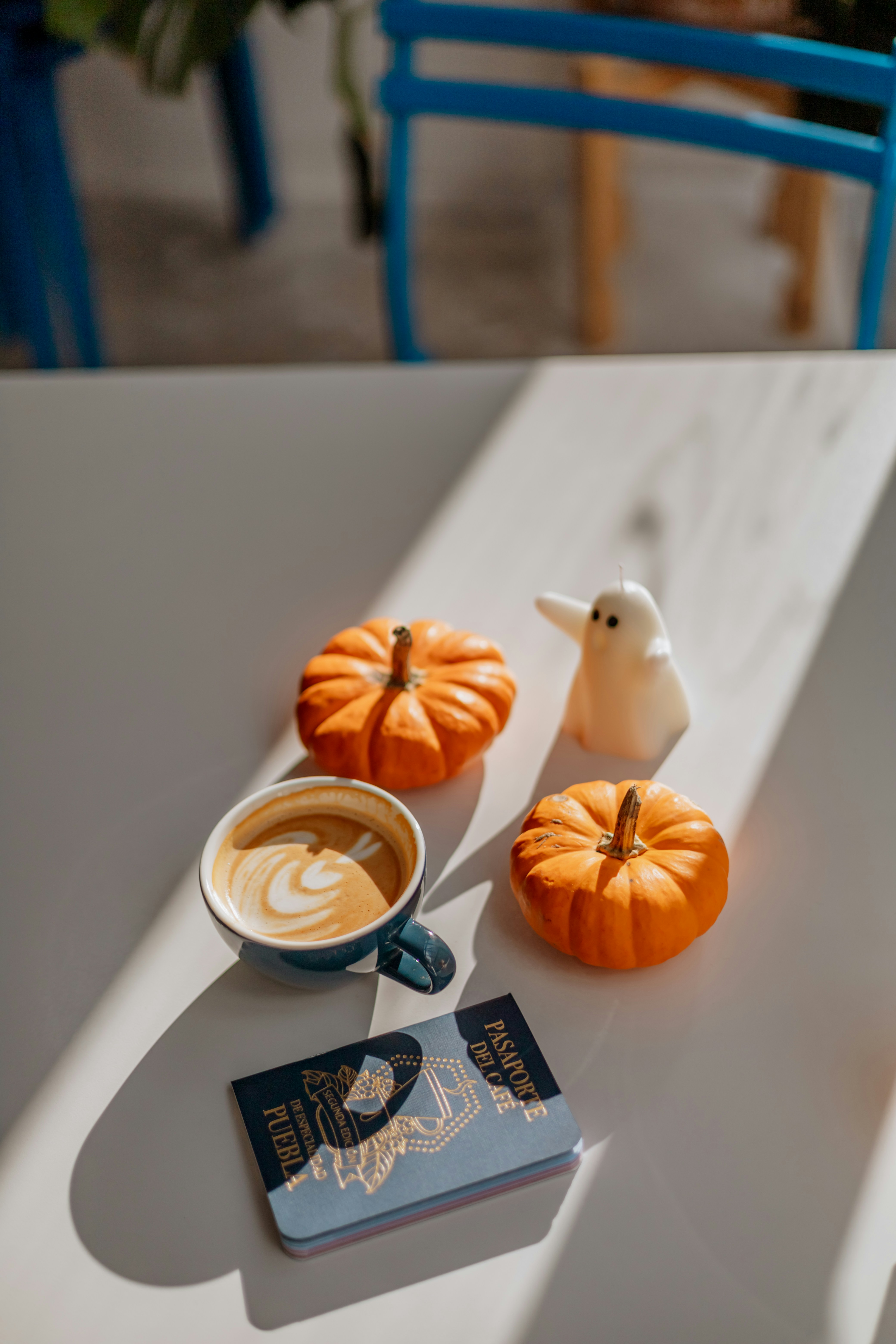 A cup of coffee sitting on top of a white table