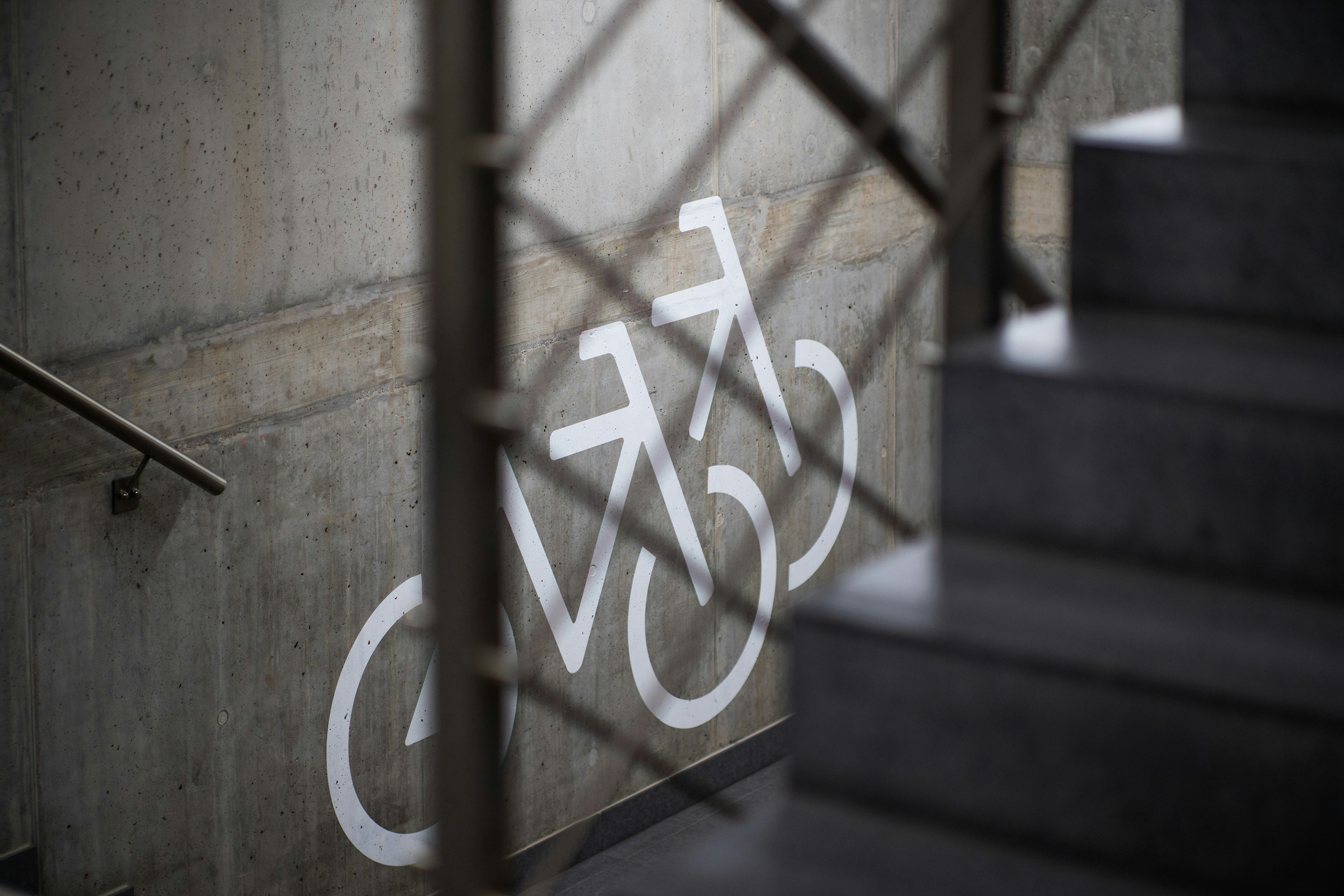 Bicycle underground parking lot staircase with concrete wall storage solution