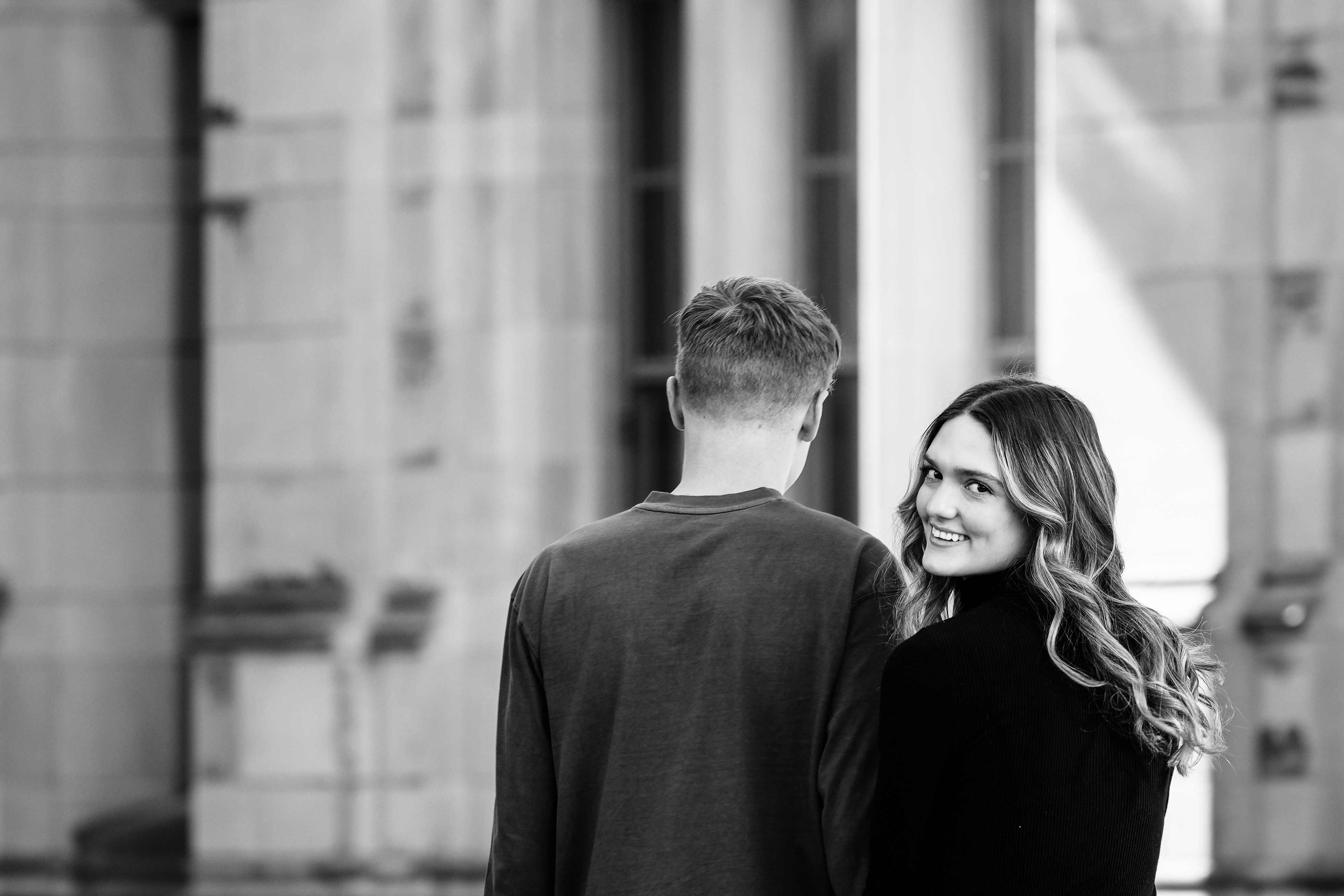 A man and a woman walking down a street