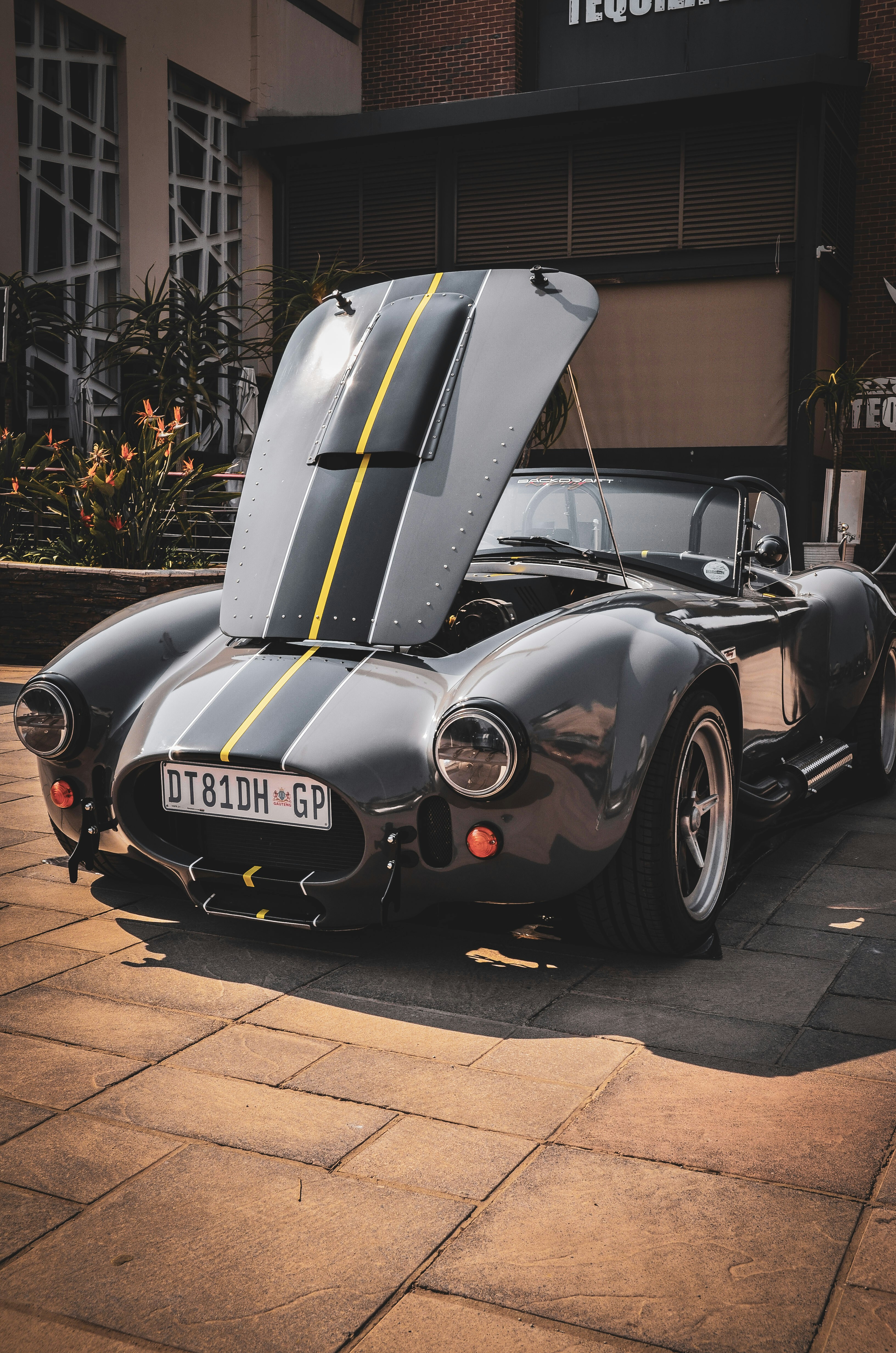 A black sports car parked in front of a building