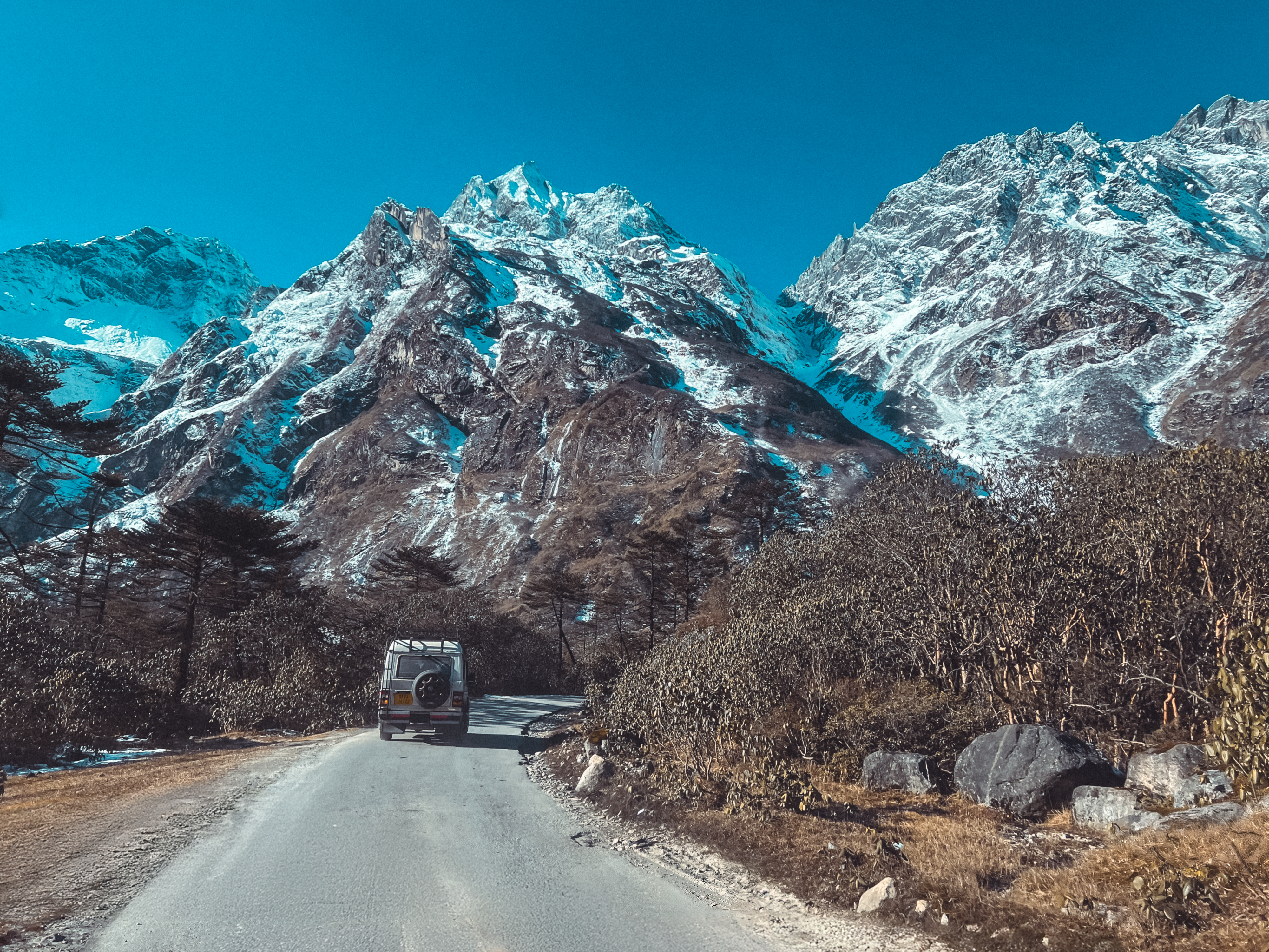 A truck is driving down a mountain road