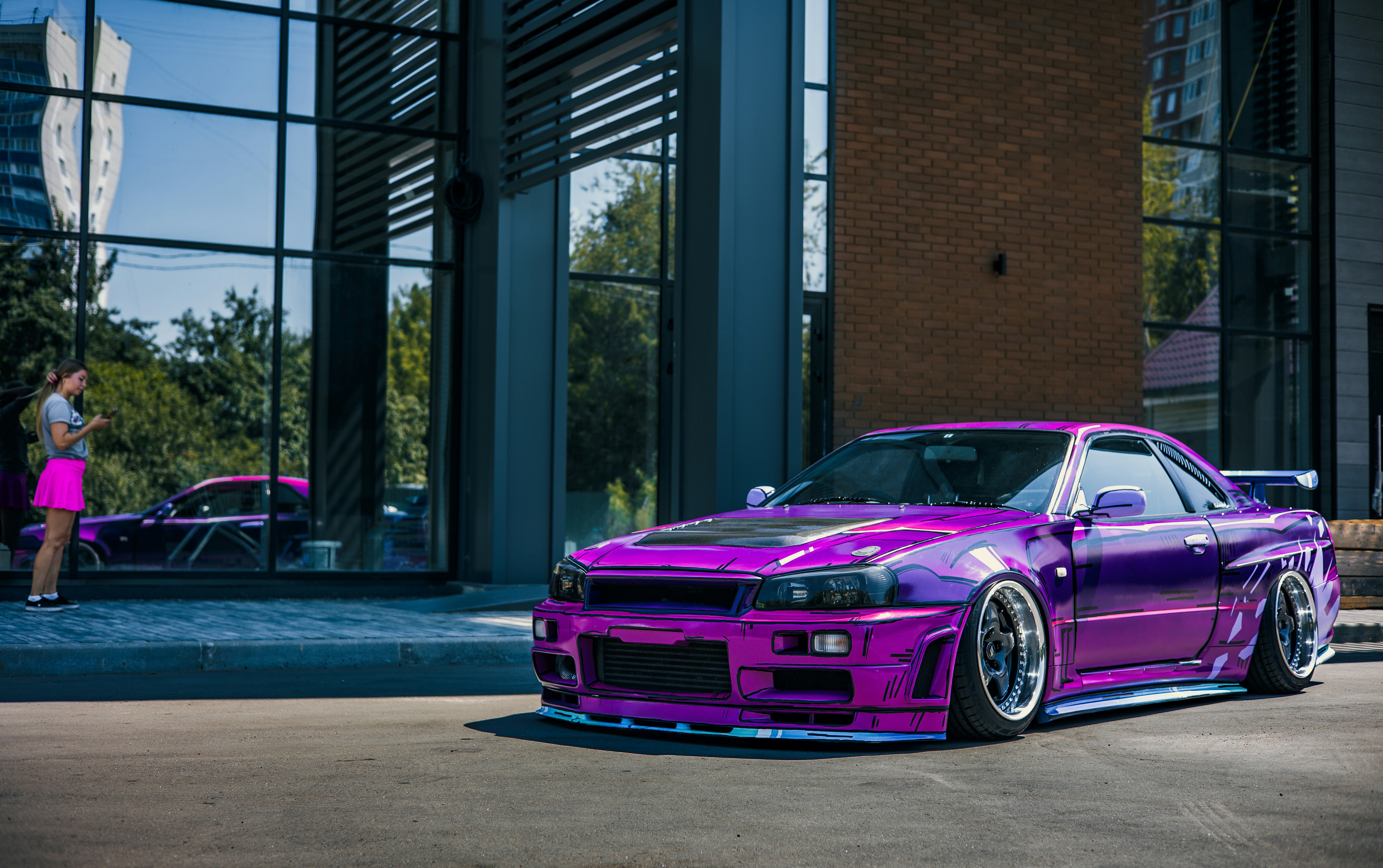 A purple car parked in front of a building