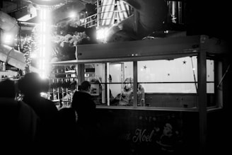 A black and white photo of people at a bar