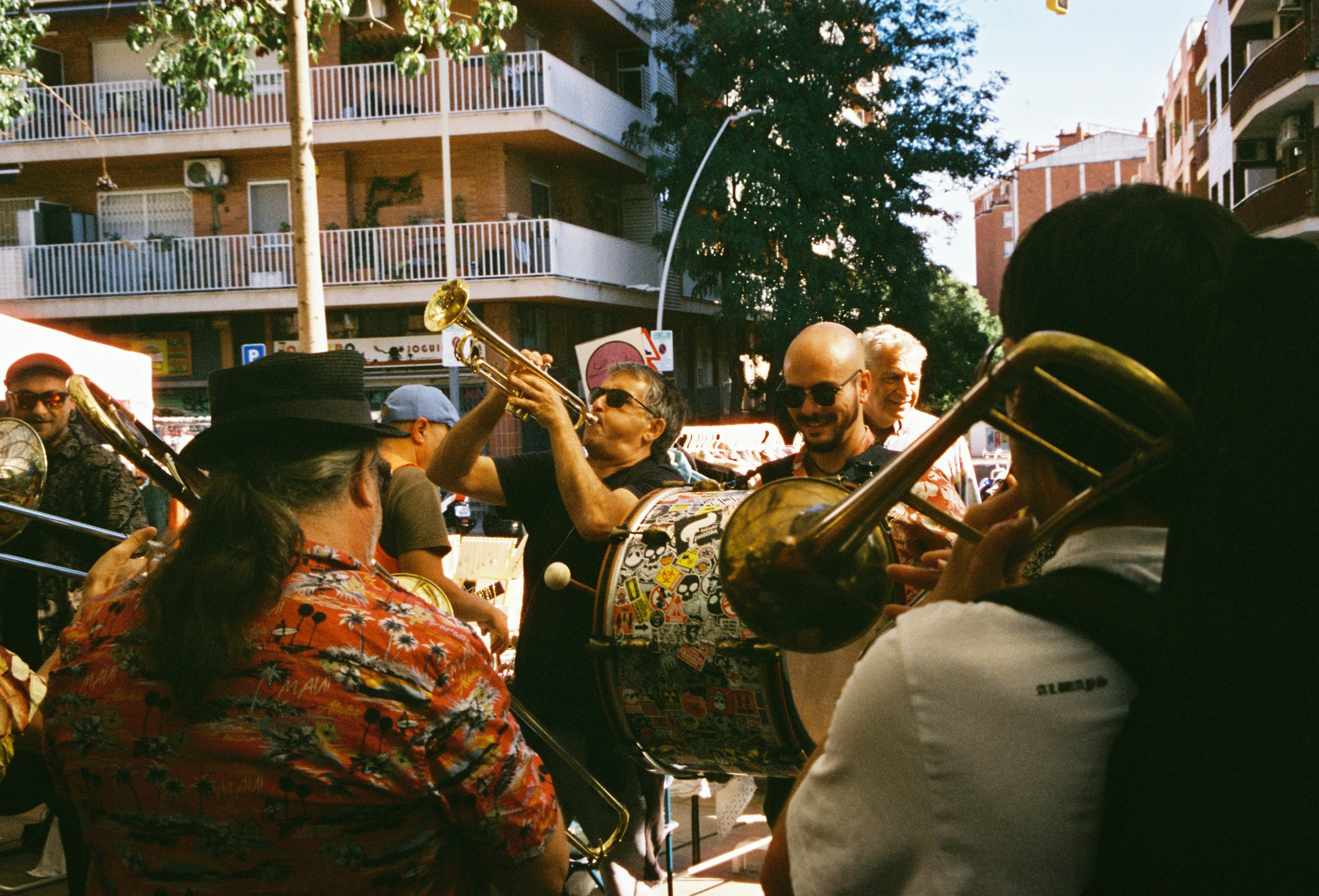 A group of people playing musical instruments on a city street