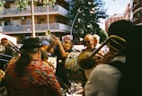 A group of people playing musical instruments on a city street