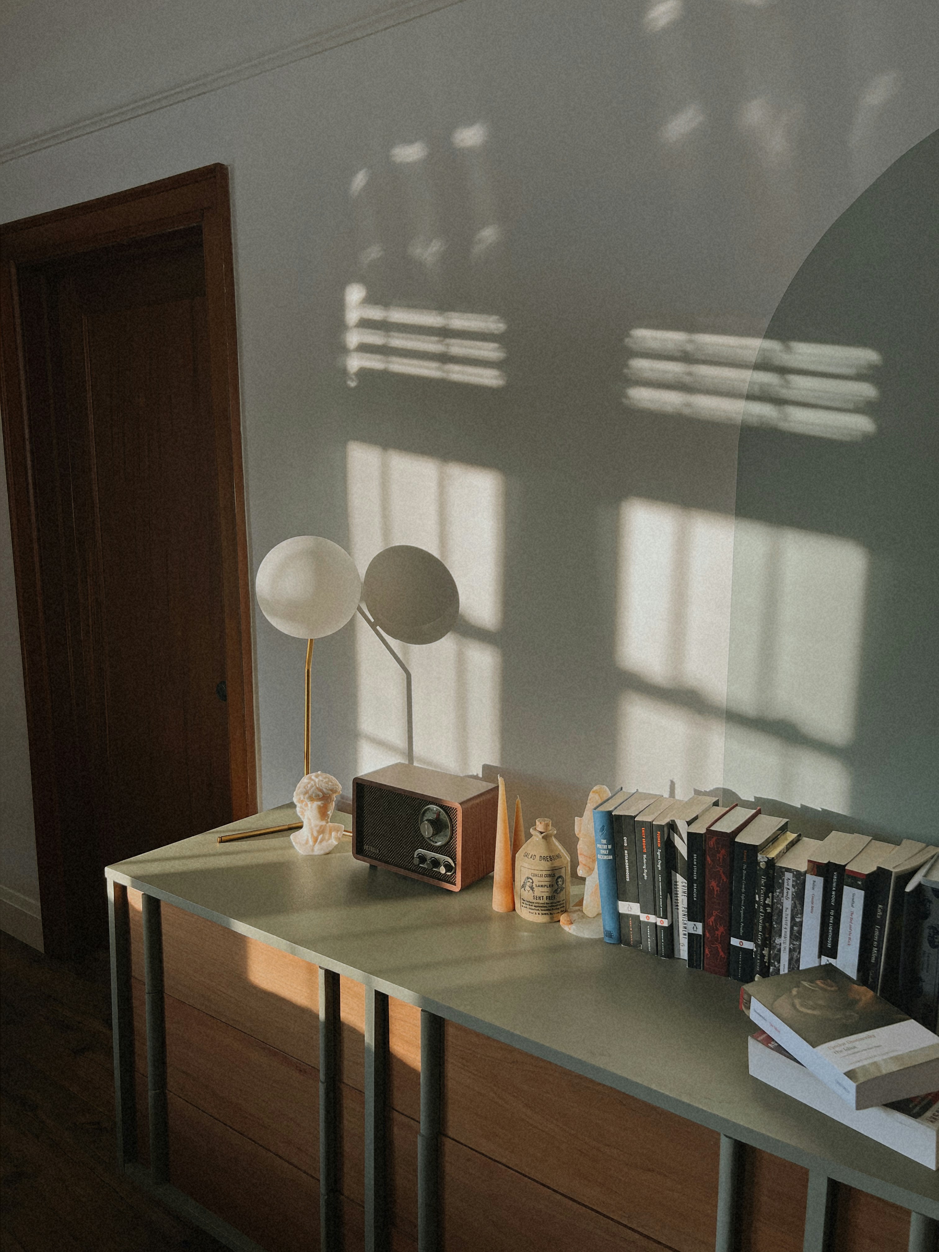 A table with books and a lamp on top of it