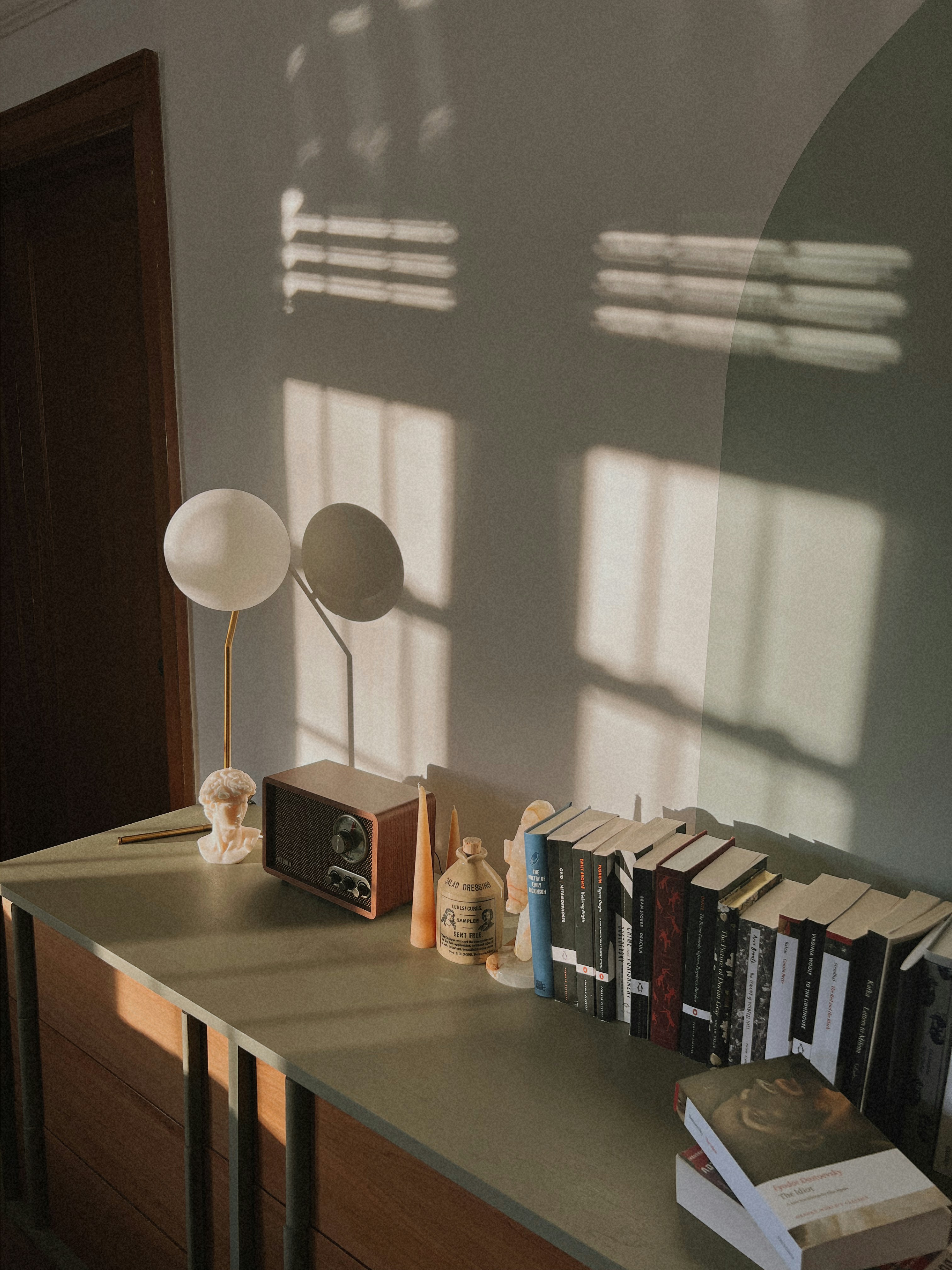 A table with a lamp and books on it