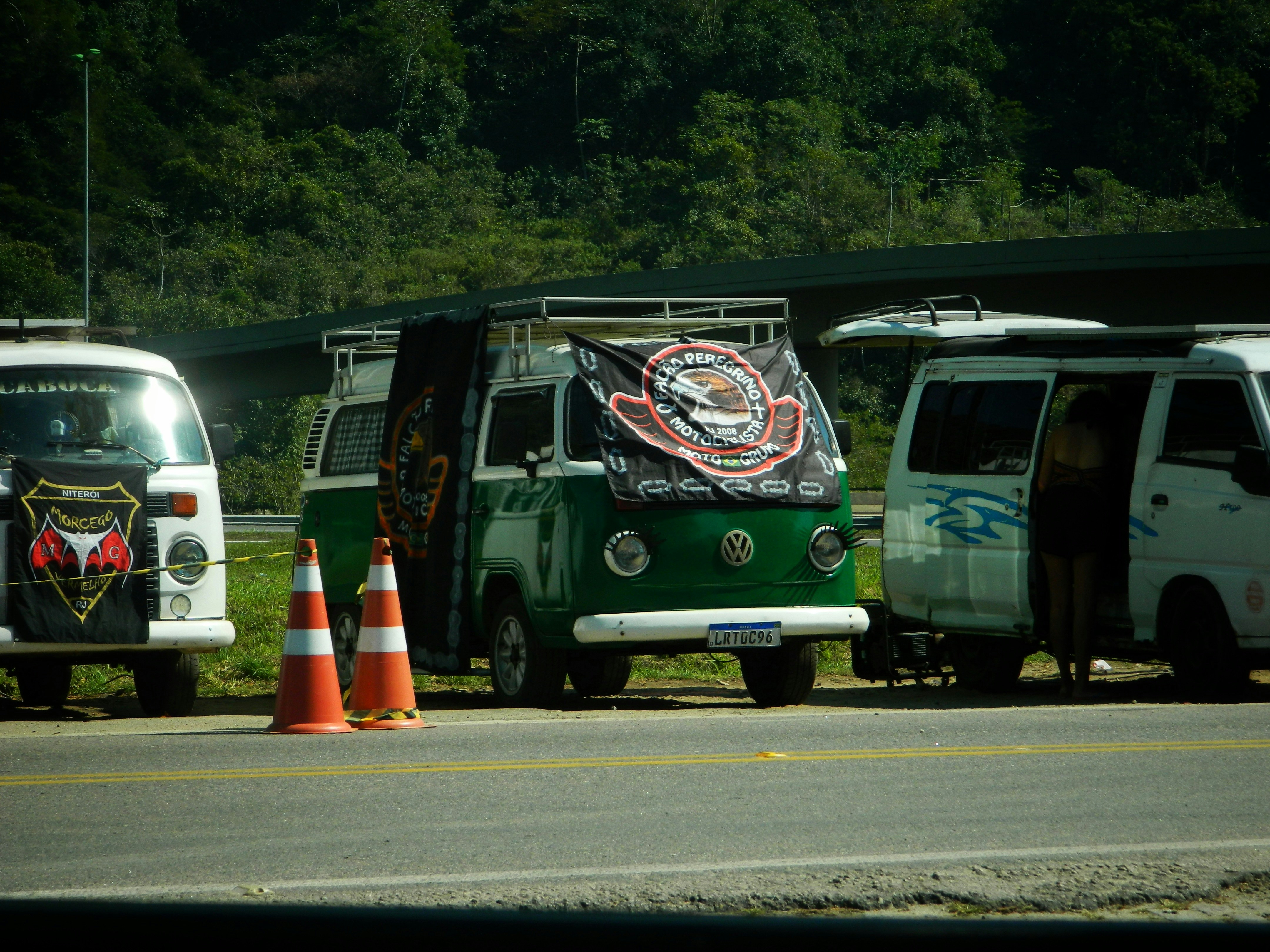 A group of vans parked on the side of a road