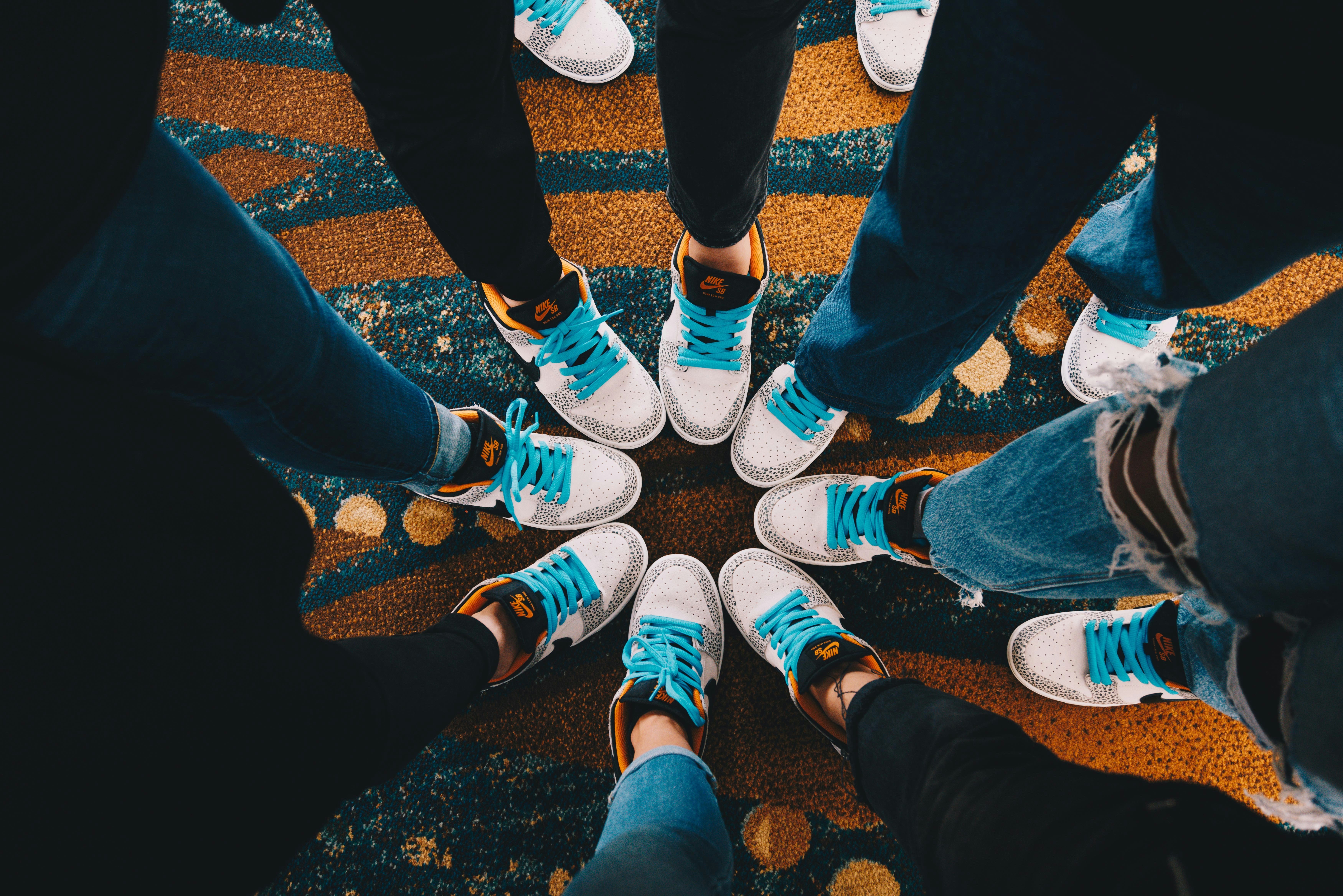 A group of people standing in a circle, 