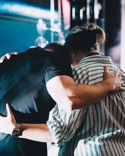 A couple of people that are hugging each other