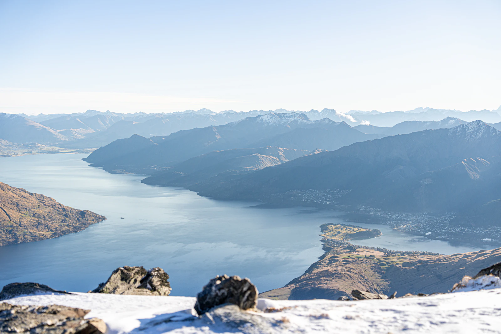 A skier looking out from a snowy southern hemisphere summit