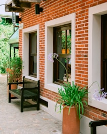 A couple of benches sitting next to a brick building