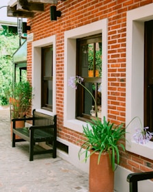 A couple of benches sitting next to a brick building