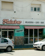 Two cars parked in front of a restaurant