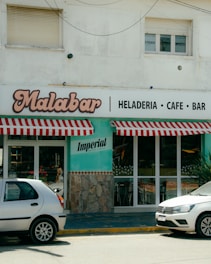 Two cars parked in front of a restaurant