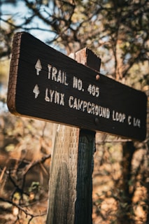 A trail sign is posted on a wooden post