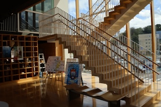 A room with a staircase and a book shelf