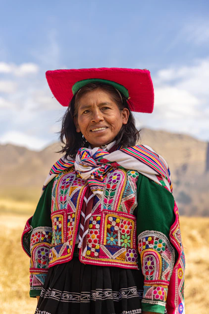 A woman wearing a colorful hat and dress