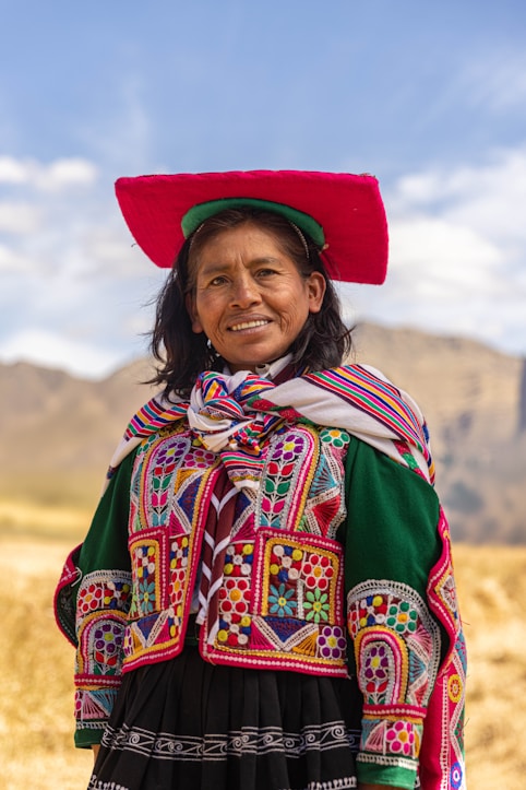 A woman wearing a colorful hat and dress