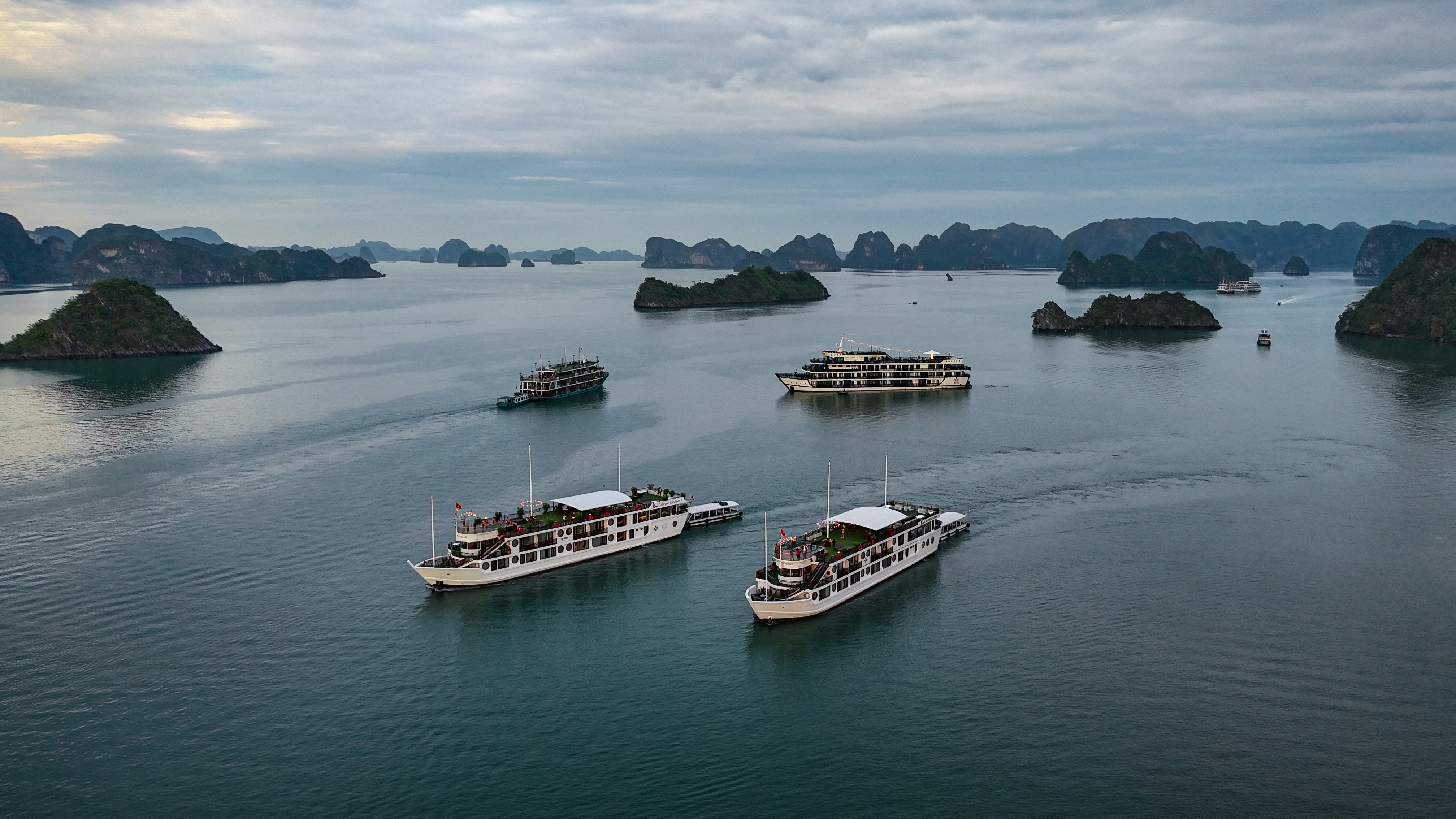 A group of boats floating on top of a large body of water