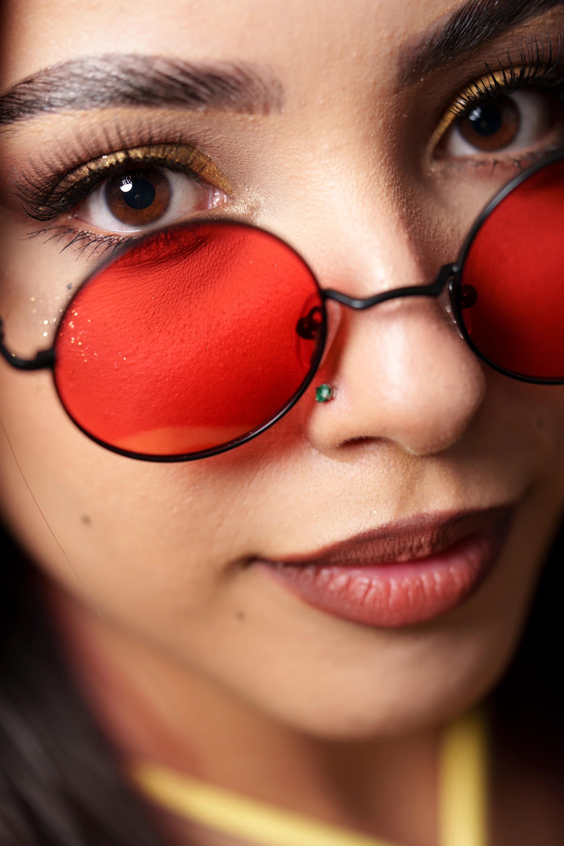 A woman with a pair of red glasses on her face